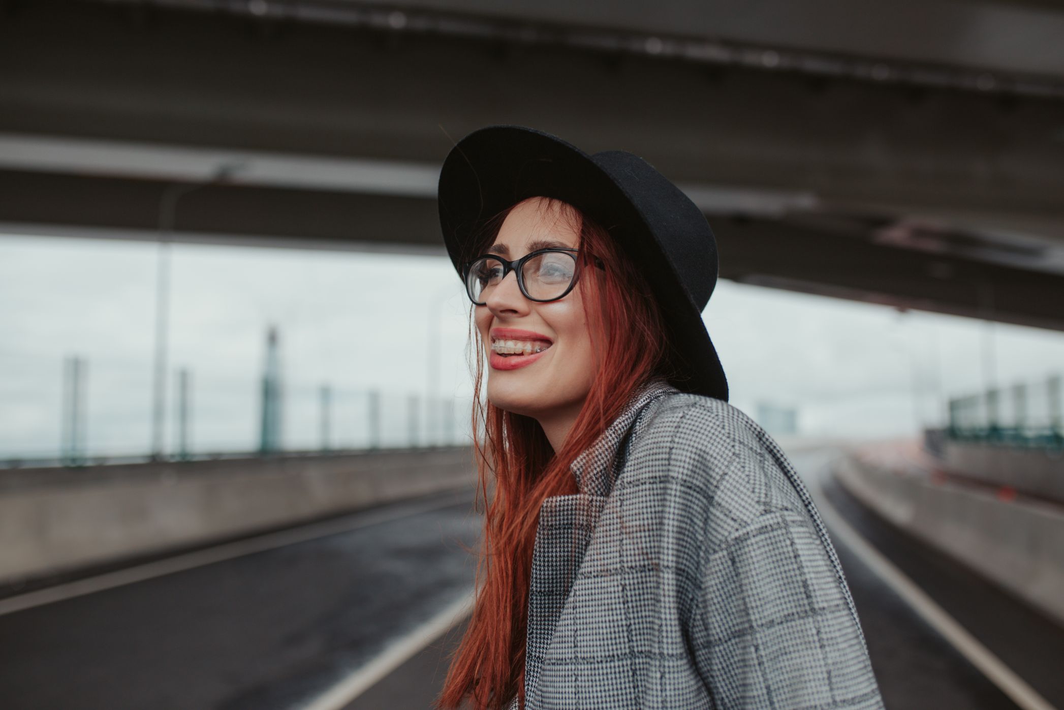young-woman-with-red-hair-laughing-with-braces